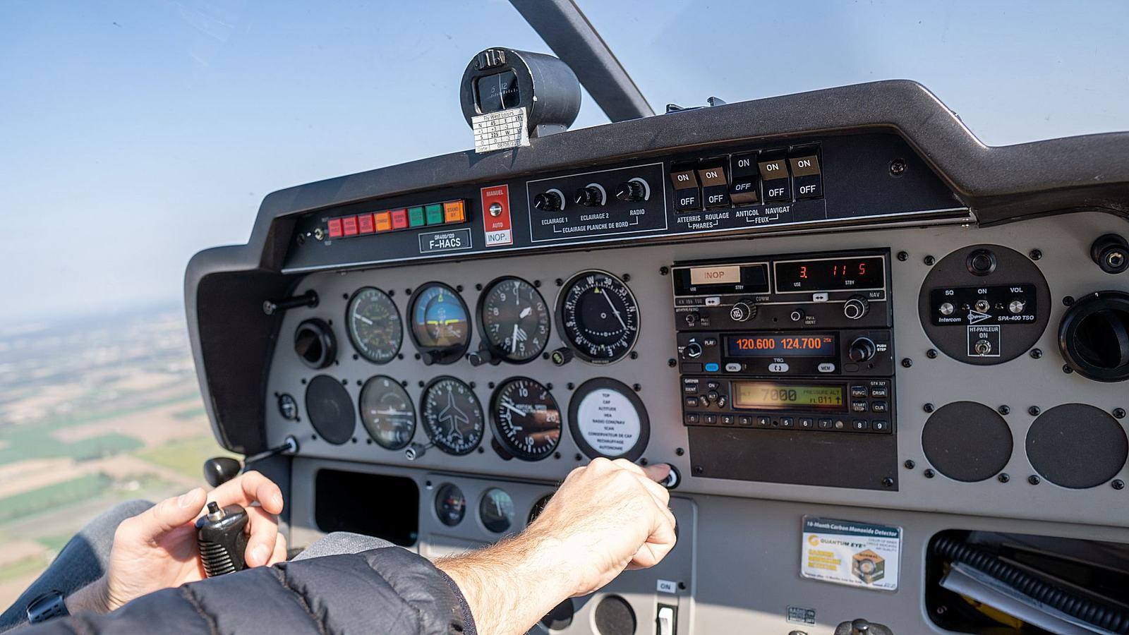 Vue depuis le cockpit d’un avion du club en vol au-dessus de la campagne